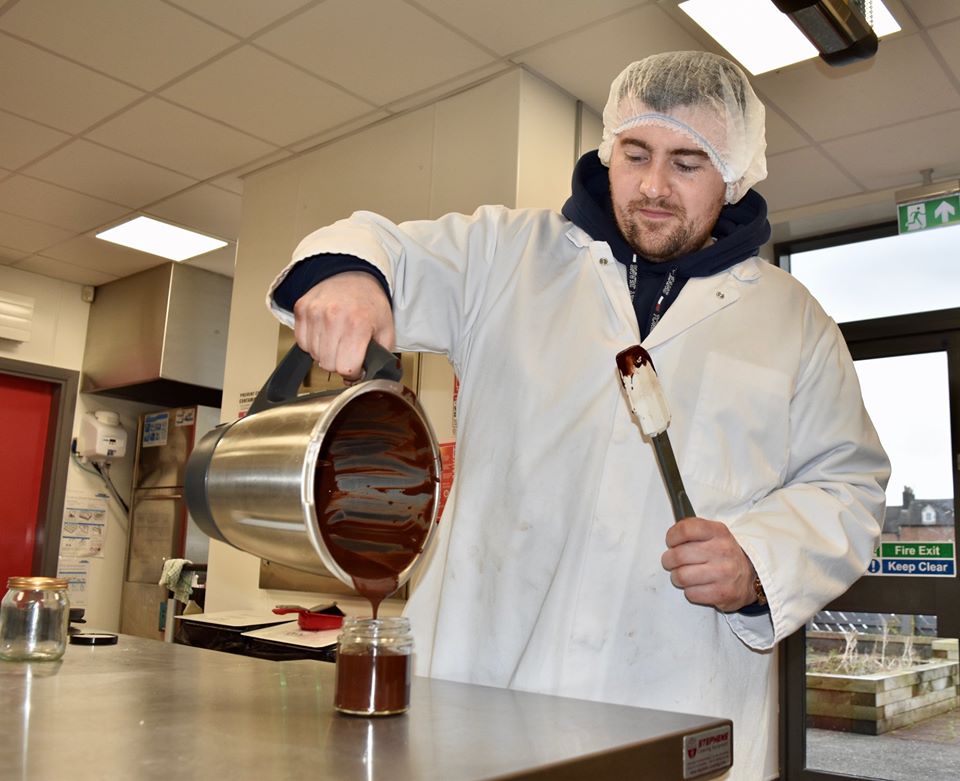 Anthony Gillen of Foyle Bubble Waffles pouring his locally made chocolate hazelnut spread into test jars in NWRC Foodovation Centre.