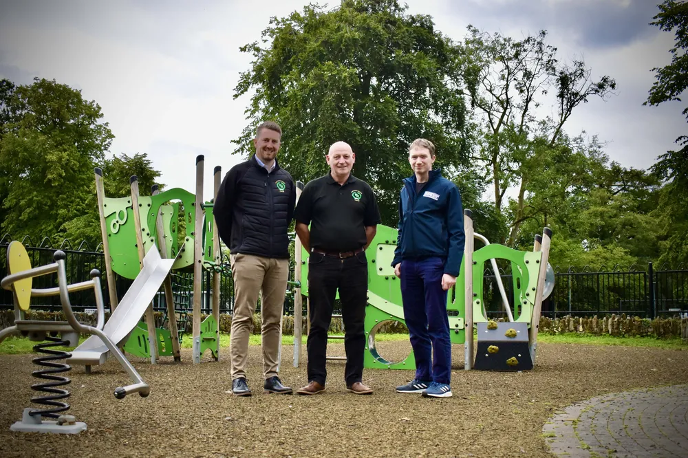 A group of men standing in a Play Park