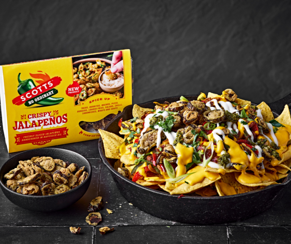A bowl of nachos and a box of food.