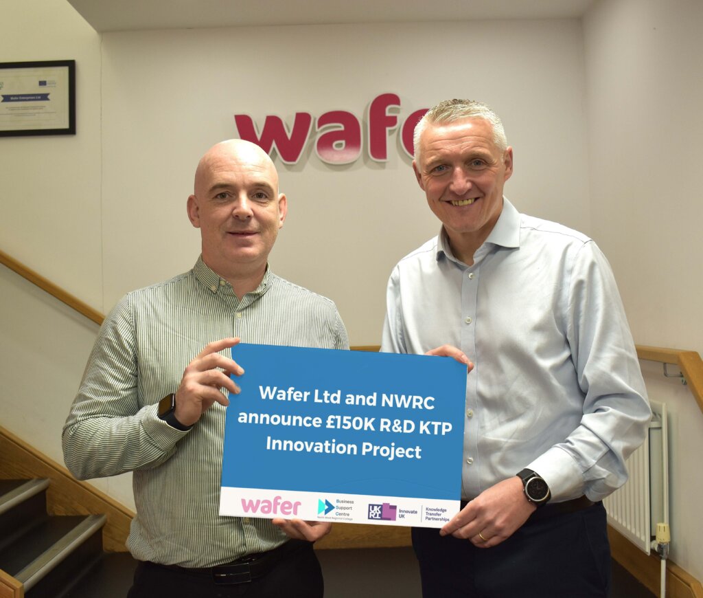 Men holding a sign in front of stairs.